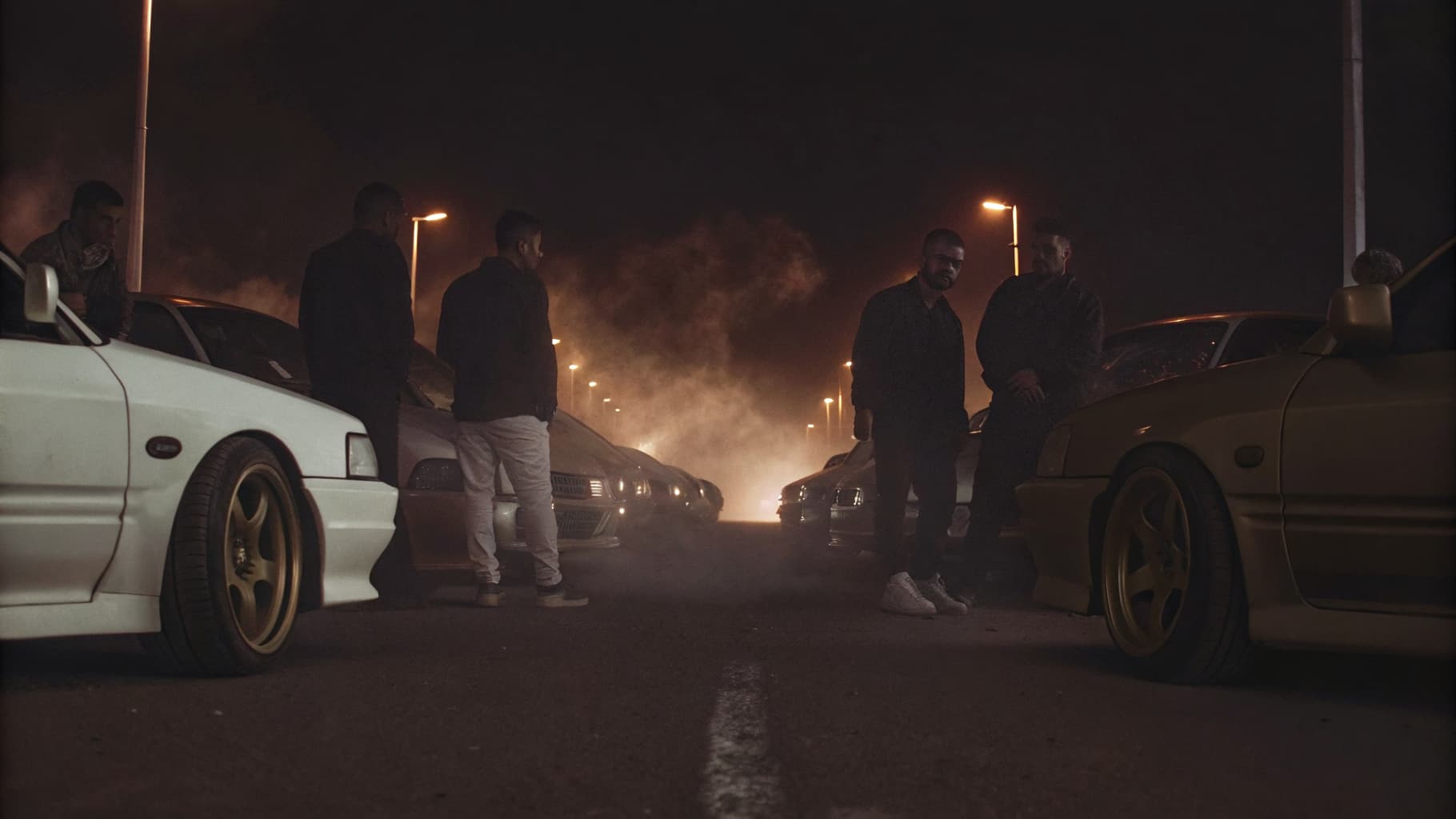 Drift community gathered around modified JDM coupes at night